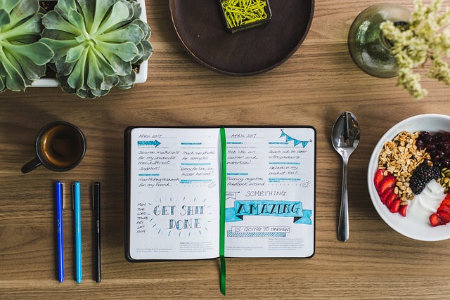 calm workspace with journal notebook and coffee cup on wooden desk